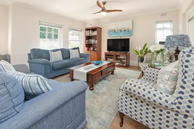 a living room with blue couches and a tv at Mountain View by Top Destinations Rentals in Hermanus