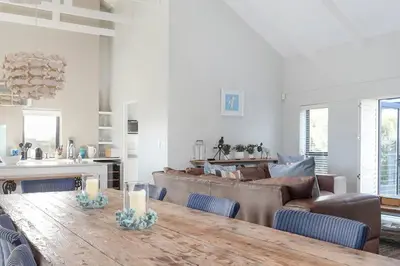 a living room with a table and a couch at Kingklip by Top Destinations Rentals in Hermanus