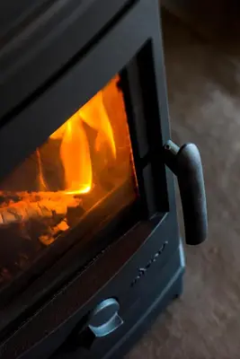 a stove with a fire inside of it at Bains View Olive and Guest Farm in Wellington