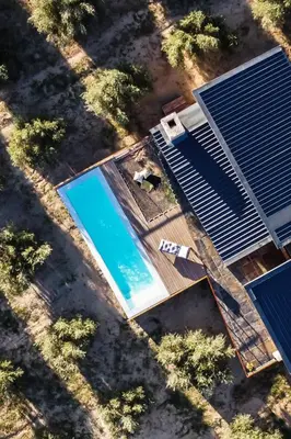 an overhead view of a swimming pool next to a house at Bains View Olive and Guest Farm in Wellington