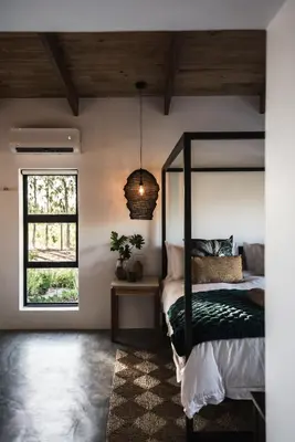 a bedroom with a poster bed and a window at Bains View Olive and Guest Farm in Wellington