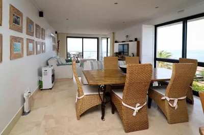 a dining room with a table and chairs at Hermanus Seaview Apartment in Hermanus