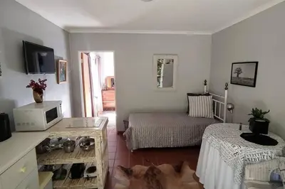 a living room with a dog laying on the floor at Garden cottage in Cape Town