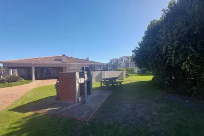a backyard with a grill and a picnic table at First Group Hermanus Beach Club in Hermanus