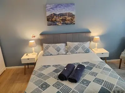 a bedroom with a bed with two pillows on it at Leafy Retreat Kenridge in Durbanville