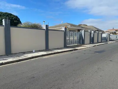 a fence on the side of a road next to a street at SABATH LODGE TWO in Cape Town