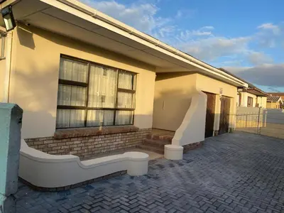 a house with a window and a brick patio at SABATH LODGE TWO in Cape Town
