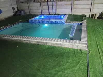 a large swimming pool with a pathway around it at Sunrise Lodge in Cape Town