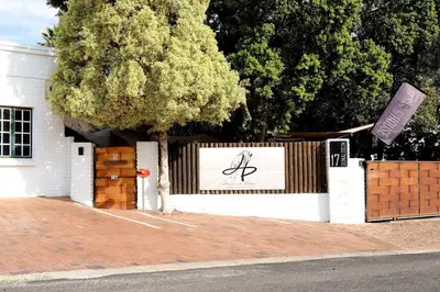 a white building with a sign on the side of it at House of Perez in Wellington