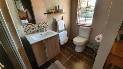 a small bathroom with a sink and a toilet at House of Perez in Wellington