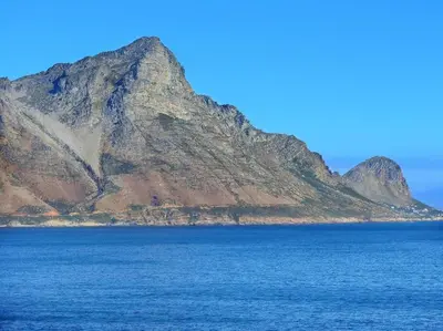 an island in the middle of a body of water at The Whale and Waddler - Unit with a view in Kleinmond