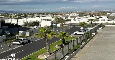 an aerial view of a parking lot with cars at 2 Bedroom Oceanfront Apartment with Sea Views in Cape Town
