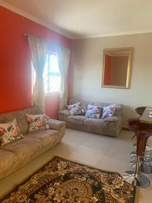 a living room with two couches and a mirror at manu'z in Cape Town