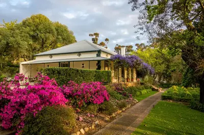 a house with flowers in front of it at Bartholomeus Klip Farmhouse at Elandsberg Nature Reserve in Hermon