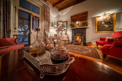 a living room with two glass vases on a table at Bartholomeus Klip Farmhouse at Elandsberg Nature Reserve in Hermon