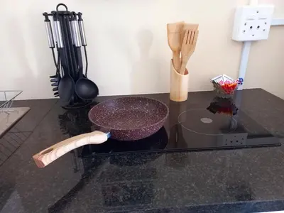 a mortar and pestle on a counter with utensils at Cozy Strand Beach Getaway - Studio Apartment in Cape Town