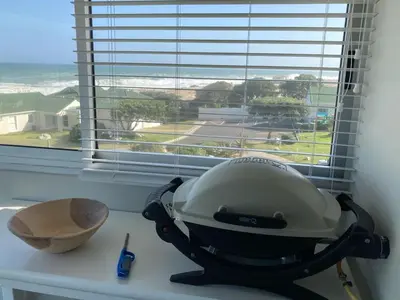 a kitchen counter with a mixer and a bowl on a window at 31 Tobago Bay in Hermanus