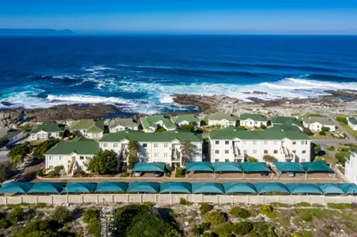 an aerial view of a resort with the ocean at 31 Tobago Bay in Hermanus