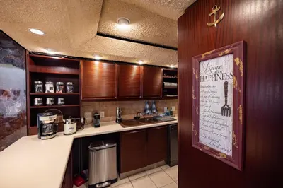 a kitchen with a sink and a counter top at Beach2Anchor, Beachfront 4 bedroom condo with Jacuzzi in Gordonʼs Bay