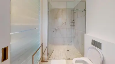 a bathroom with a shower and a toilet at Stamford on Sea by Top Destinations Rentals in Hermanus