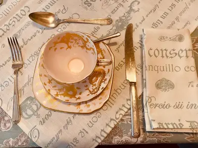 a cup of coffee on a plate on a table at Boord Guest House in Stellenbosch