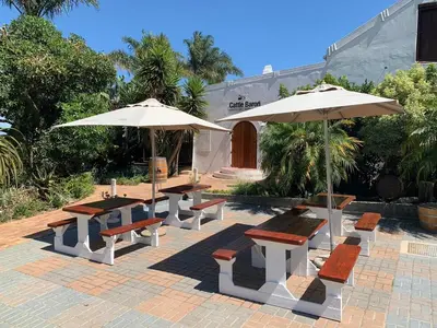 a group of tables and umbrellas on a patio at Saxenburg Wine Farm in Kuilsrivier