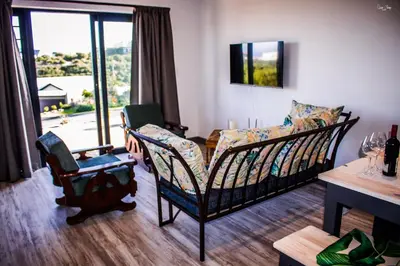 a living room with a couch and chairs and a table at 41 on Siffie in Hermanus