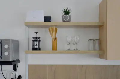 a shelf with two wine glasses and a coffee maker at 108 Waverley in Cape Town