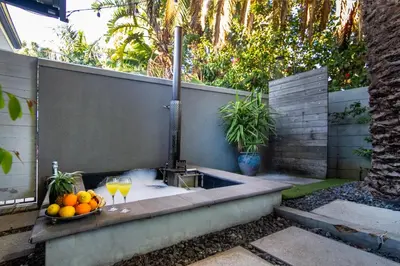 a bath tub with a fountain with oranges and wine glasses at Vygeboom Villa/ Durbanville in Cape Town
