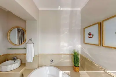 a bathroom with a white tub and a sink at The Links by Top Destinations Rentals in Hermanus