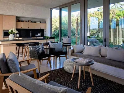 a living room with a couch and a table at Stonehaven Eco Cabins in Hermanus