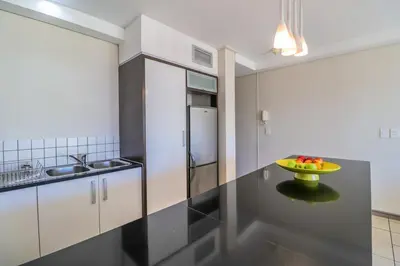 a kitchen with a bowl of fruit on a counter at Manhattan Towers 506 by CTHA in Cape Town