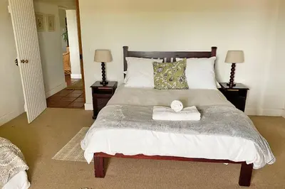 a bedroom with a large bed with two night stands at Lagoon View in Hermanus in Hermanus