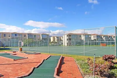 a tennis court with two tennis courts at Hermanus Beach Club 31 in Hermanus