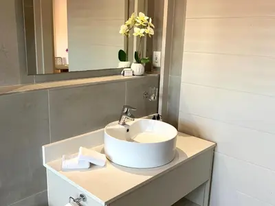 a bathroom with a sink and a mirror at Hermanus Waterfront Apartment in Hermanus