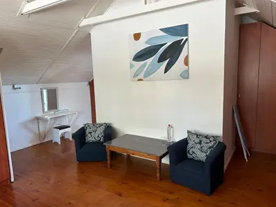 a living room with a table and two chairs at Paradyskloof Suite in Stellenbosch