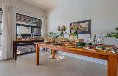 a dining room with a table with food on it at Ladybird Boutique Hotel at Kanonkop in Stellenbosch