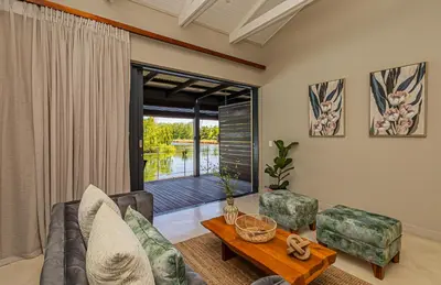 a living room with a couch and a table at Ladybird Boutique Hotel at Kanonkop in Stellenbosch