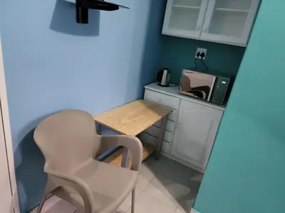 a small kitchen with a table and a chair at Hasate Guest House ,4 st james street Oakdale Belliville Cape Town South Africa in Cape Town