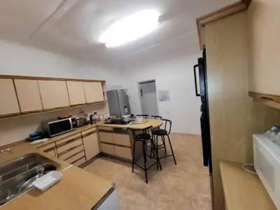 a kitchen with a sink and a table in it at Zenith House Boston Self Catering Accomodation in Cape Town