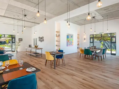 a dining room with tables and chairs at Glow Boutique Suites & Guesthouse in Hermanus