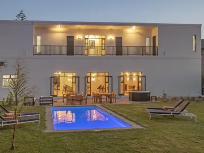 a house with a swimming pool in the yard at Glow Boutique Suites & Guesthouse in Hermanus