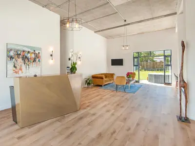 a living room with a large painting on the wall at Glow Boutique Suites & Guesthouse in Hermanus
