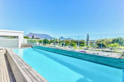 a swimming pool with a view of the mountains at 2 Bedroom Secure Pool Strong WiFi in Cape Town