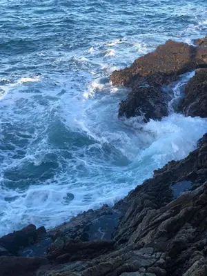 a view of the ocean from a rocky beach at OnTheRocksBB Solar Powered Guesthouse and Ocean Lodge in Bettyʼs Bay