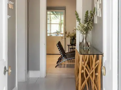 a hallway with a table and chairs and a glass counter at Greyton Lodge in Greyton