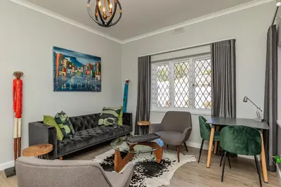 a living room with a couch and a table at Spacious Guest Apartment in Rondebosch in Cape Town