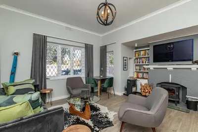 a living room with a couch and a fireplace at Spacious Guest Apartment in Rondebosch in Cape Town