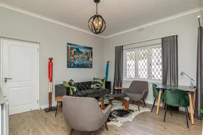 a living room with a couch and a table at Spacious Guest Apartment in Rondebosch in Cape Town