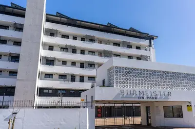 a large white building with a sign on it at Burmeister403 - Modern 1 Bedroom Apartment across from Ocean in Cape Town